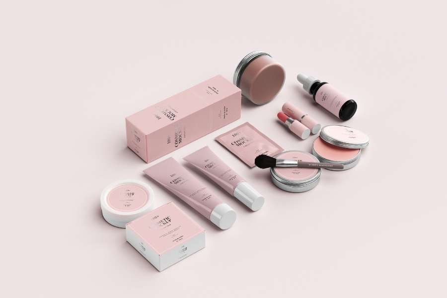 Flat lay of skincare and cosmetic products in pastel pink packaging, highlighting the importance of Beauty Product Expiration Dates.